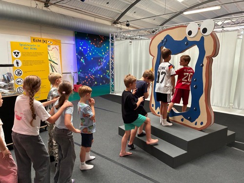 Bild vom Besuch der MIMA in Ingelheim, Kinder gehen durch eine riesig große Toastscheibe zur Ausstellung.